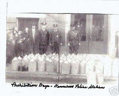 Dennison police pose with confiscated alcohol during Prohibition days in Tuscarawas County.