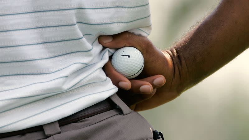 Tiger Woods holds a Nike golf ball while waiting for his turn to putt during second round action in the Bridgestone Invitational Golf Tournament at the Firestone Country Club in Akron, OH, on Friday, Aug. 3, 2007.