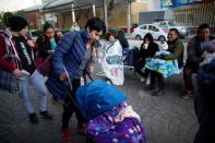 Esperanza Paz pushes the trolley with her son, Hermes Soto, as they wait outside a hospital in Mexico City