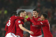 Manchester United players celebrate after Manchester United's Scott McTominay, centre, scored his side's opening goal during the English Premier League soccer match between Manchester United and Arsenal at Old Trafford in Manchester, England, Monday, Sept. 30, 2019. (AP Photo/Dave Thompson)