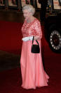 <p>Before the fash pack knew millennial pink was soon to be the ‘It’ hue of the moment, the Queen chose the colour for the red carpet – miniature handbag in tow. (Getty Images)</p> 