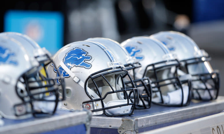 Detroit Lions helmets sitting on the sideline.