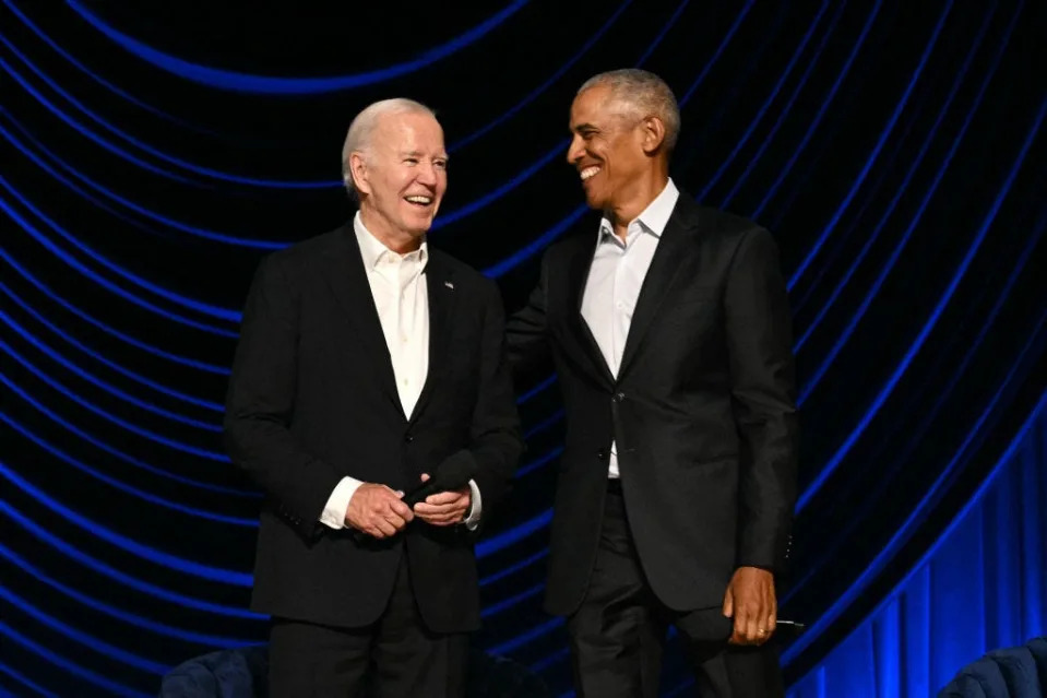 Joe Biden and Barack Obama onstage at a campaign fundraiser.