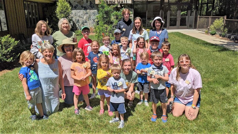 Children pose with camp counselors at a past Wild Wonder camp at St. John in the Wilderness.