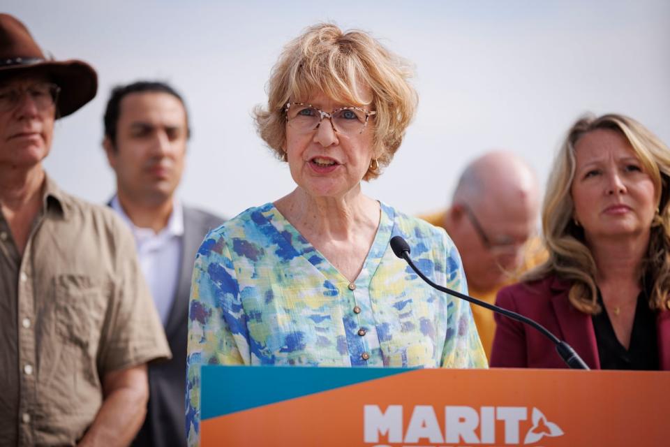 Helen Brenner, a member of Stop Sprawl Durham, speaks alongside NDP Leader Marit Stiles at a press conference in the Duffins Rouge Agricultural Preserve, in Pickering, Ont., on Aug. 15, 2023.