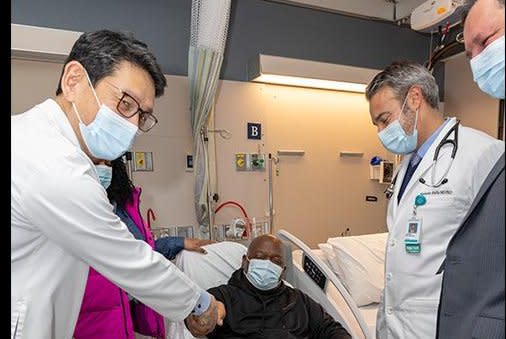 Rick Slayman, the man who received a transplanted gene-edited pig kidney at Massachusetts General Hospital, shakes Dr. Tatsuo Kawai’s s hand as Dr. Riella and Dr. Kawai look on. Photo courtesy of Massachusetts General Hospital