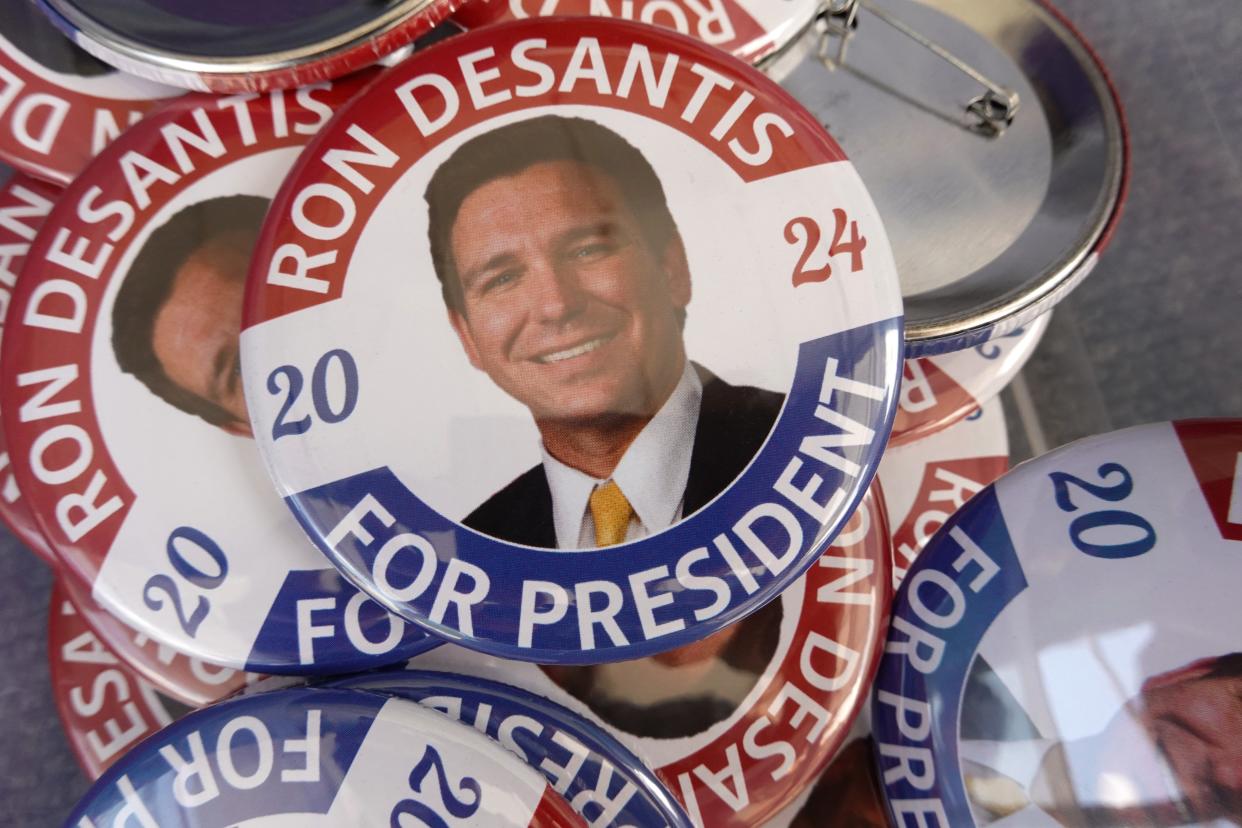 A vendor sells buttons before the start of a campaign event for Republican presidential candidate Ron DeSantis at Eternity Church on May 30, 2023 in Clive, Iowa (Getty Images)