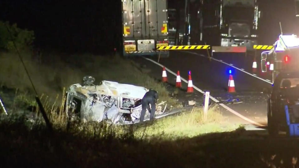 A police officer examines the wreckage of Charmaine Harris McLeod's car following the crash at the Bunya Highway near Kingaroy on Monday night.