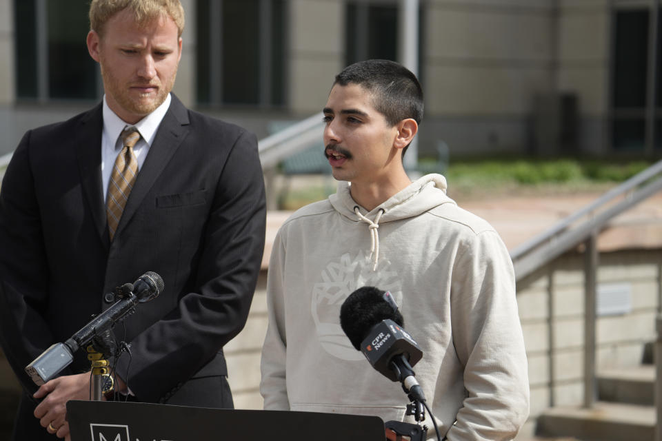 Kevin Mehr, attorney representing Kenneth Espinoza, left, and Kenneth's son Nathaniel, speak at a news conference, Tuesday, May 2, 2023, outside the federal courthouse in Denver. Kenneth Espinoza says he was repeatedly stunned with a Taser while handcuffed, including once in the face, and is suing a Colorado sheriff’s department. The suit filed this week alleges excessive force by two deputies from the Las Animas County Sheriff's Office. (AP Photo/David Zalubowski)