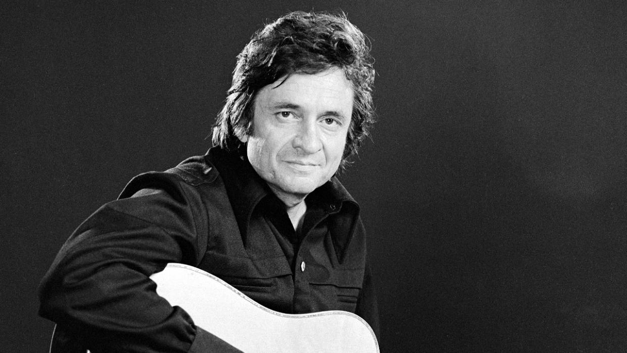  Johnny Cash with his guitar in 1974. 