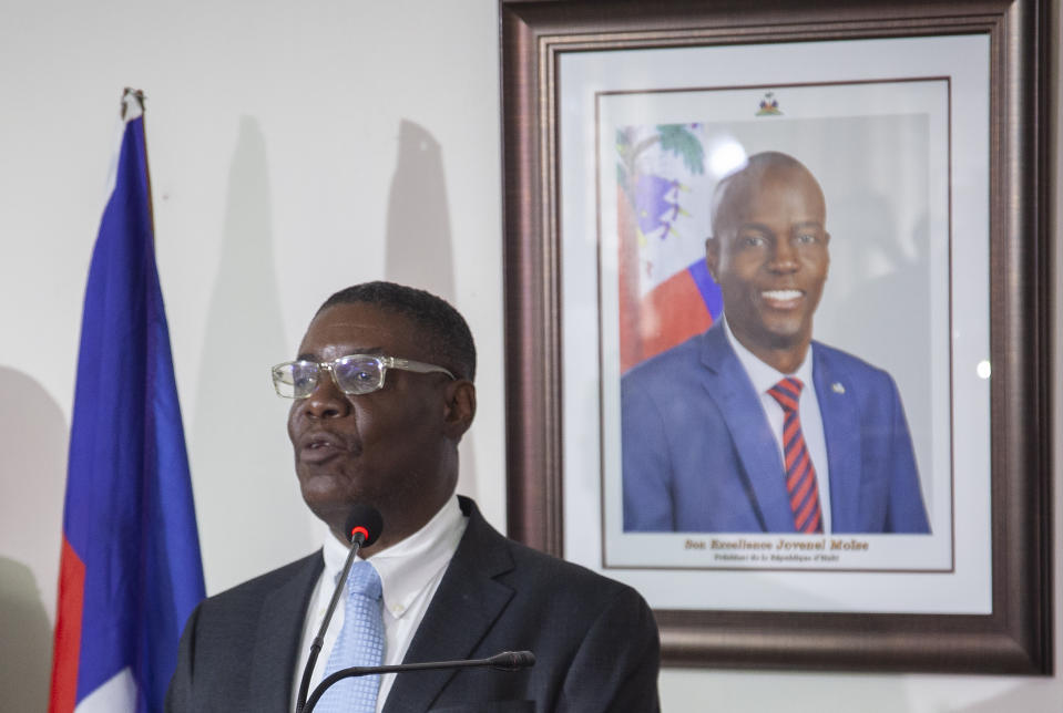 Haiti's newly-named Justice Minister Liszt Quitel, speaks during his installation ceremony, backdropped by a photo of assassinated President Jovenel Moise, in Port-au-Prince, Haiti, Thursday, Sept. 16, 2021. (AP Photo/Richard Pierrin)