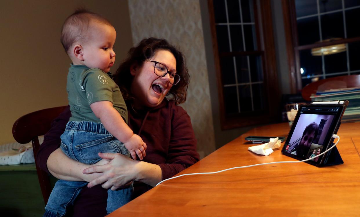 Stacie Bryant, with grandson Milo, video chats with her son, Tyler, from her dining room on Feb. 8 in Hobart. Tyler is serving 90 days at Oconto County Jail