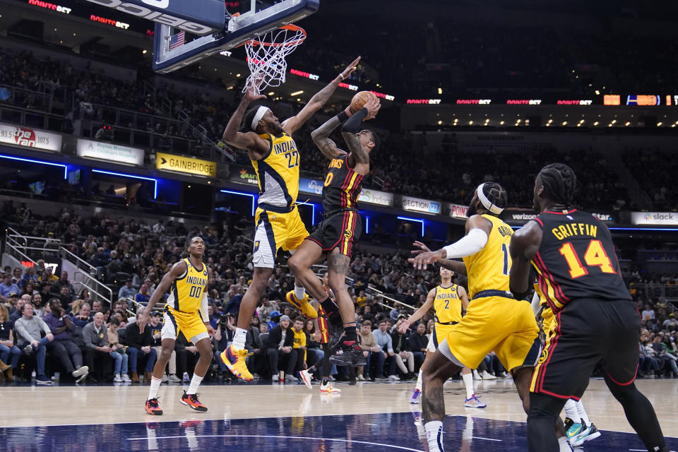 Atlanta Hawks' John Collins (20) shoots against Indiana Pacers' Isaiah Jackson during the first half of an NBA basketball game Friday, Jan. 13, 2023, in Indianapolis. (AP Photo/Darron Cummings)