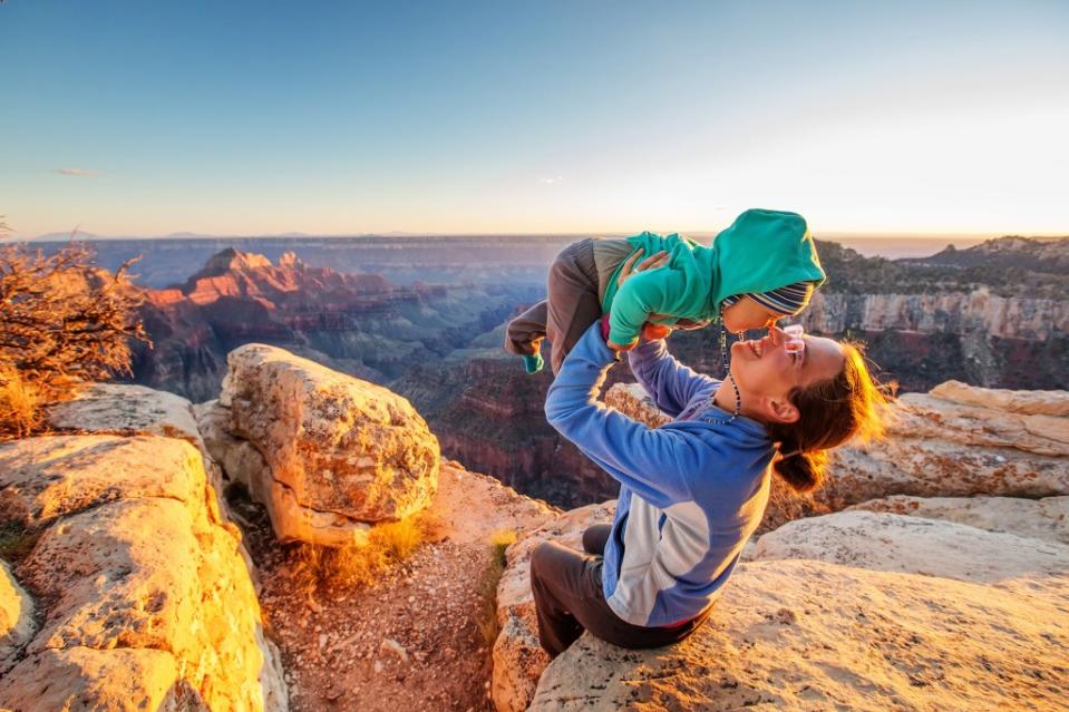 A mother holds her young son in the North Rim of Grand Canyon National Park in Arizona. Maygutyak – stock.adobe.com