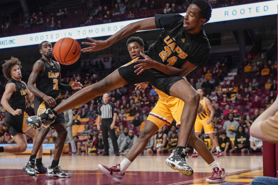 Arkansas-Pine Bluff guard AC Curry (24) passes the ball before going out of bounds against Minnesota during the first half of an NCAA college basketball game on Wednesday, Dec. 14, 2022, in Minneapolis. (AP Photo/Craig Lassig)