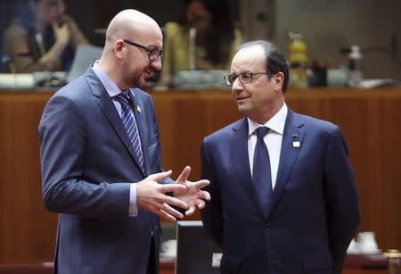 Belgium's Prime Minister Charles Michel talks to France's President Francois Hollande (R) during an European Union leaders summit in Brussels October 23, 2014. REUTERS/Francois Lenoir