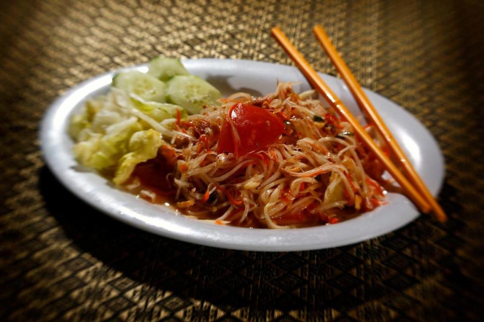 In the green papaya salad, the fruit is shredded and served with fresh shrimp and chopped peanuts.