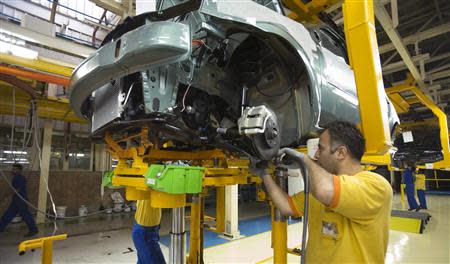 Employees work at Iran Khodro's joint venture assembly plant with France's Renault to make the Logan car, sold locally as the Tondar, 14 km (9 miles) west of Tehran, in this September 22, 2007 file photo. REUTERS/Raheb Homavandi/Files