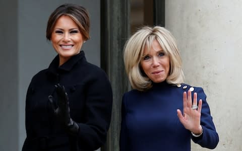 Brigitte Macron, wife of French President Emmanuel Macron, greets US first lady Melania Trump at the Elysee Palace in Paris - Credit: REUTERS