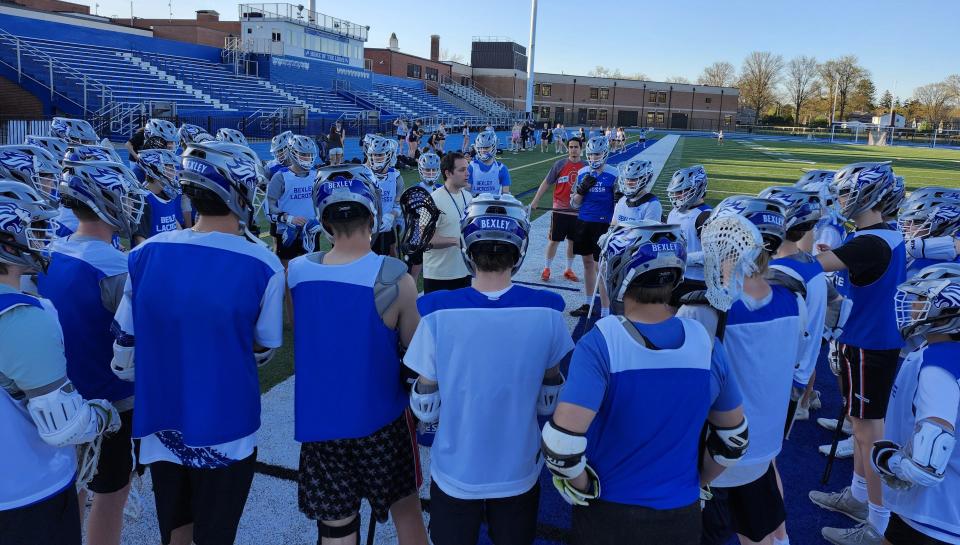 Bexley assistant coach Christian Adkin addresses the team before Monday's practice. The Lions are out to an 8-1 start, exceeding last year's win total by one.