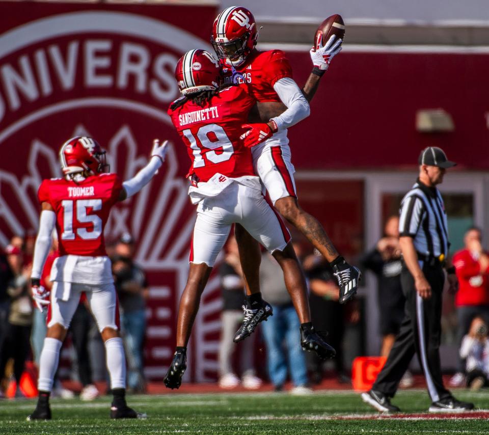 Indiana’s Josh Sanguinetti (19) and Kobee Minor (5) celebrate a turnover during the second half of the Indiana versus Wisconsin football game at Memorial Stadium on Saturday, Nov. 4, 2023.