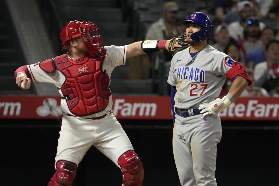 Chicago Cubs' Seiya Suzuki, right, stands by after striking out as Los Angeles Angels catcher Chad Wallach throws the ball back during the ninth inning of a baseball game Thursday, June 8, 2023, in Anaheim, Calif. (AP Photo/Mark J. Terrill)