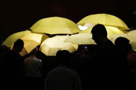 Pro-democracy lawmakers carrying yellow umbrellas, symbols of the Occupy Central movement, meet journalists after leaving a Legislative Council meeting to boycott the government in Hong Kong in this January 7, 2015 file photo. REUTERS/Bobby Yip/Files