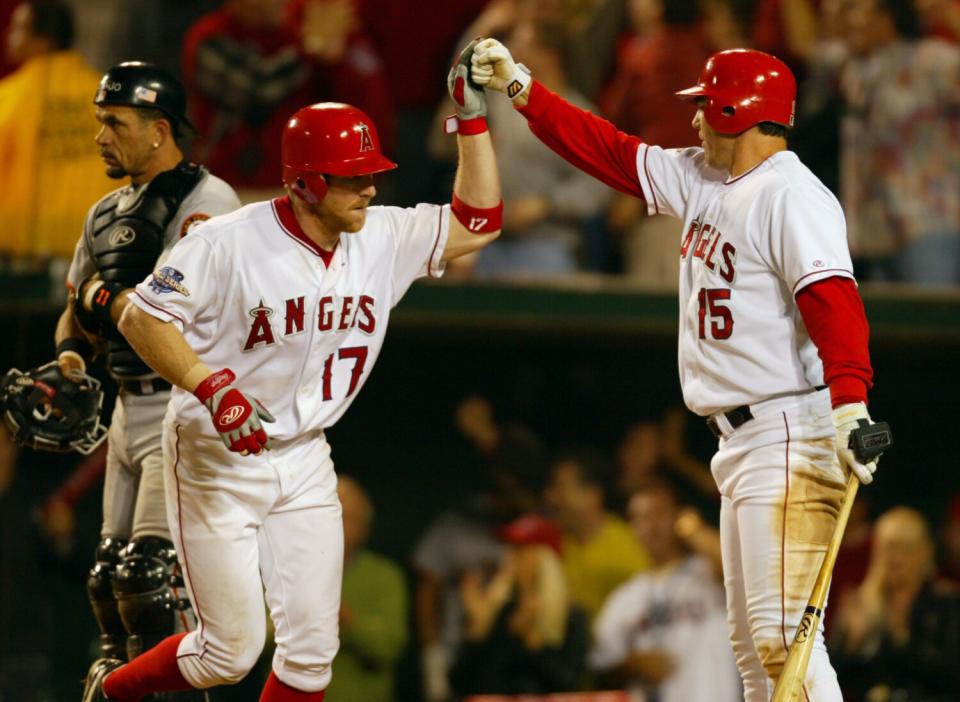 Angels' Darin Erstad high fives Tim Salmon after hitting a home run.