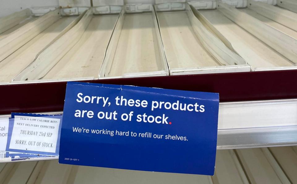 Empty shelves in the drinks section of a branch of Tesco in Liverpool - PA