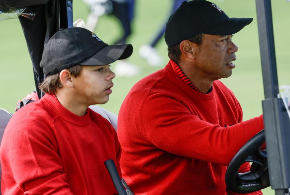 Tiger Woods, right, and Charlie Woods, left, drive down the 3rd fairway during the final round of the PNC Championship golf tournament Sunday, Dec. 18, 2022, in Orlando, Fla. (AP Photo/Kevin Kolczynski)