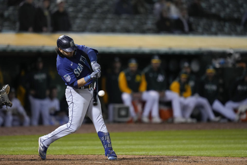 Seattle Mariners' Eugenio Suárez hits a three-run home run against the Oakland Athletics during the 10th inning of a baseball game in Oakland, Calif., Wednesday, May 3, 2023. (AP Photo/Godofredo A. Vásquez)