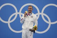 Caeleb Dressel of the United States poses with his gold medal for the men's 100-meter freestyle at the 2020 Summer Olympics, Thursday, July 29, 2021, in Tokyo, Japan. (AP Photo/Matthias Schrader)