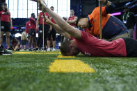 Fresno State quarterback Jake Haener stretches as he is measured at the NFL football scouting combine in Indianapolis, Saturday, March 4, 2023. (AP Photo/Michael Conroy)