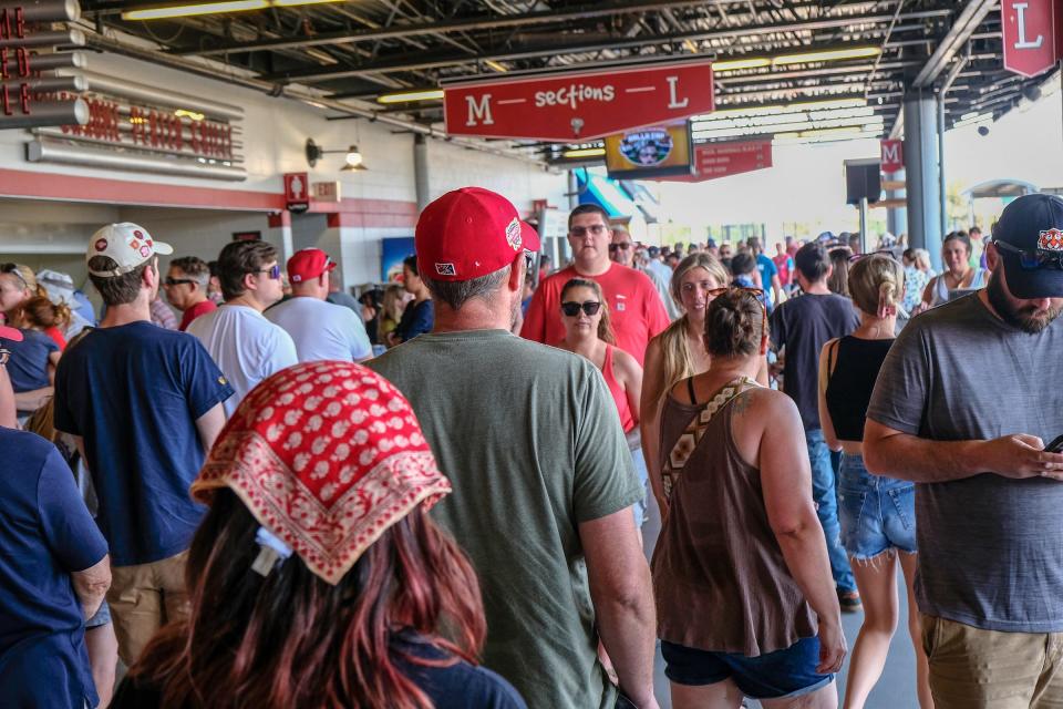 The shady mezzanine is crowded with people getting food and drinks at Jackson Field at a Lugnuts game Sunday, June 18, 2023.