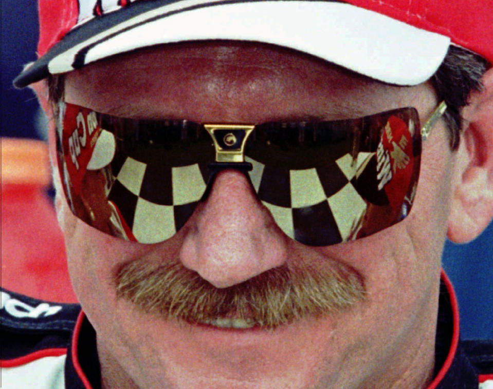 FILE - In this Feb. 13, 1997, file photo, the checkered flag in Victory Lane reflects in the sunglasses of Dale Earnhardt,, after he won his eighth consecutive 125-mile qualifying auto race for the Daytona 500 at Daytona International Speedway in Daytona Beach, Fla. On the cusp of a national popularity explosion, NASCAR never stopped after the deaths of Adam Petty, Kenny Irwin Jr. and Tony Roper. But losing Earnhardt forced the stock car series to confront safety issues it had been slow to even acknowledge, let alone address. The dramatic upgrades have saved multiple lives — NASCAR has not suffered a racing death in its three national series since — and are the hallmark of Earnhardt's legacy. (AP Photo/Terry Renna, File)