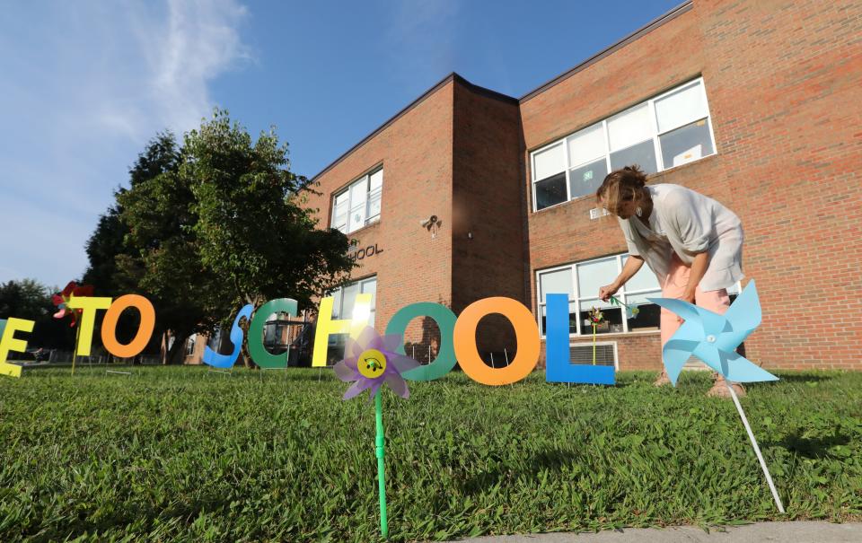 Art teacher Karen Baumann helps decorate the school grounds to welcome student for the first day of school at West Haverstraw Elementary Sept. 5, 2023.