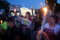 <p>People hold up candles, lights and cell phones displaying the images of a candle during a national vigil “to demand democracy” and “confront corruption” on Pennsylvania Avenue outside the White House in Washington, D.C., on July 18, 2018. (Photo: Michael Reynolds/EPA-EFE/REX/Shutterstock) </p>