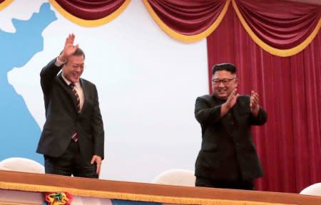 South Korean President Moon Jae-in talks with North Korean leader Kim Jong Un as they watch an art performance at Pyongyang Grand Theatre in Pyongyang, North Korea, September 18, 2018. Pyeongyang Press Corps/Pool via REUTERS