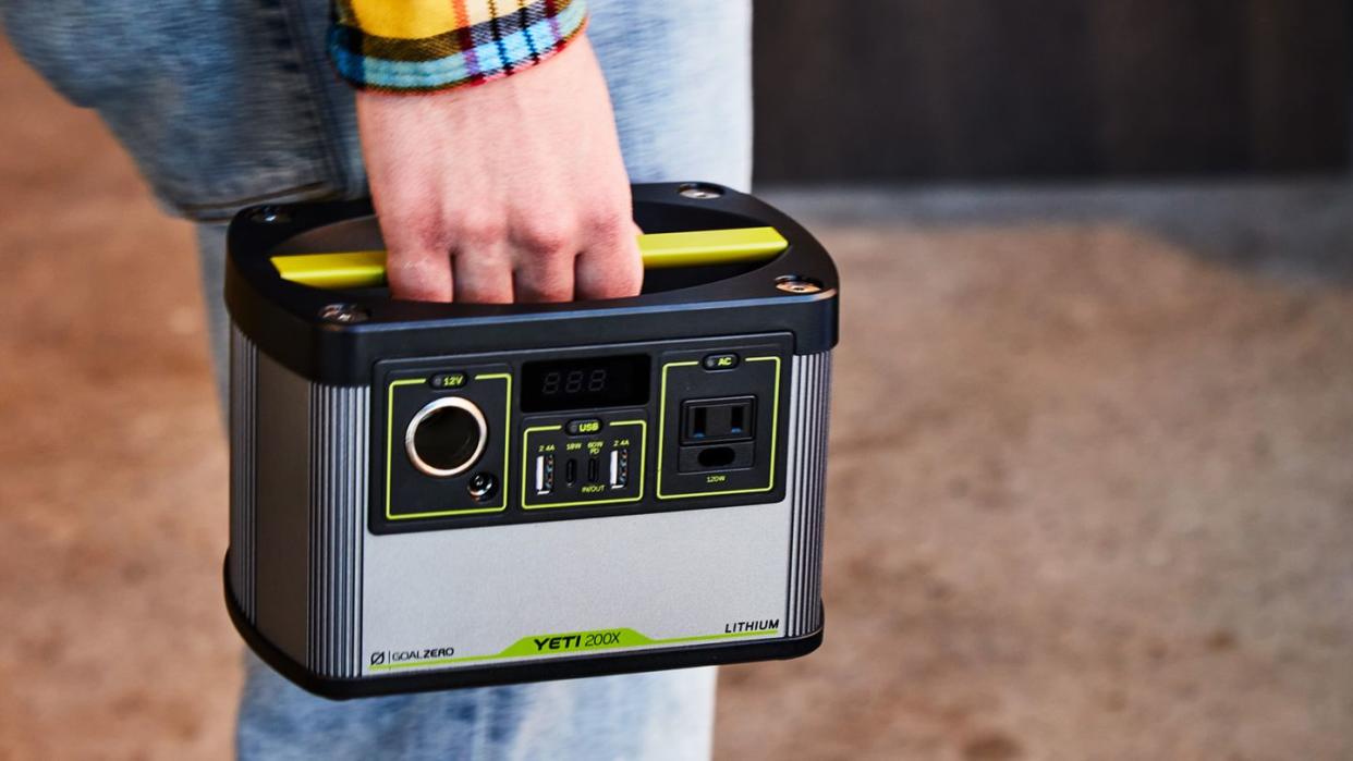 a man holding a portable generator