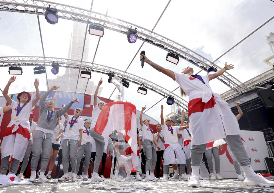 England players celebrate on stage at an event at Trafalgar Square in London, Monday, Aug. 1, 2022. England beat Germany 2-1 and won the final of the Women's Euro 2022 on Sunday. (James Manning/PA via AP)