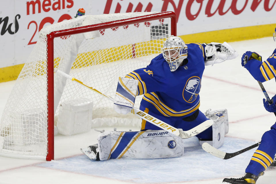 Buffalo Sabres goalie Linus Ullmark (35) makes a save during the third period of an NHL hockey game against the New York Rangers, Tuesday, Jan. 26, 2021, in Buffalo, N.Y. (AP Photo/Jeffrey T. Barnes)