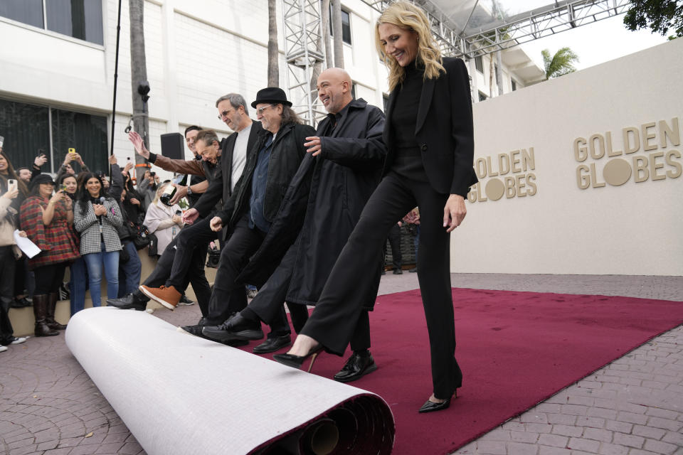 From left, Barry Adelman, Ricky Kirshner, Glenn Weiss, Jo Koy, and Helen Hoehne roll out the red carpet during the Golden Globe Awards Press Preview at the Beverly Hilton, Thursday, Jan. 4, 2024, in Beverly Hills, Calif. (AP Photo/Ashley Landis)