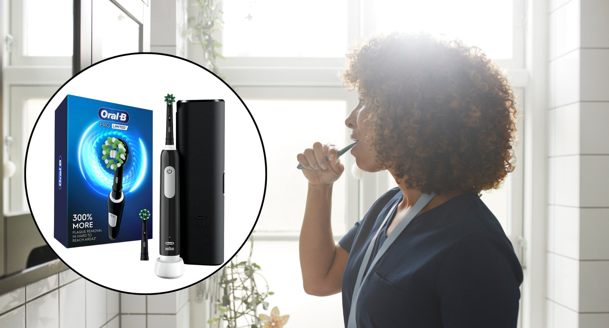 toothbrush, black woman with curly hair and blue t-shirt brushing teeth in white tile bathroom, amazon canada oral-b pro limited electric toothbrush