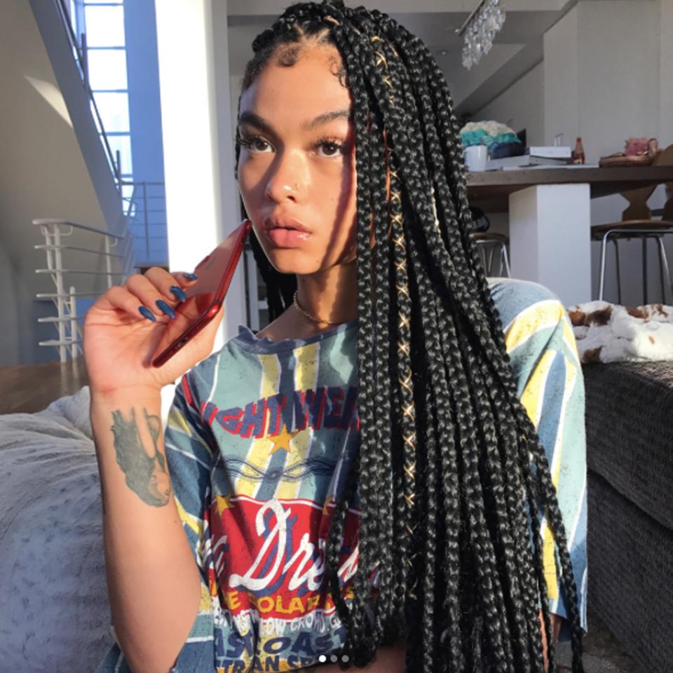 Instagram model India Love adds shine by lacing a bit of metallic gold thread around her braids.