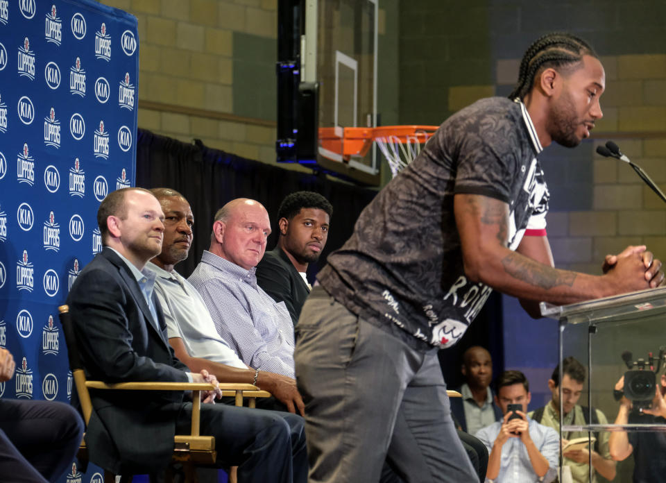 Los Angeles Clippers President of Basketball Operations Lawrence Frank, left, head coach Doc Rivers, second left, and team chairman Steve Ballmer, center, introduce Kawhi Leonard, right, and Paul George during a press conference in Los Angeles, Wednesday, July 24, 2019. Nearly three weeks after the native Southern California superstars shook up the NBA by teaming up with the Los Angeles Clippers, the dynamic duo makes its first public appearance. (AP Photo/Ringo H.W. Chiu)