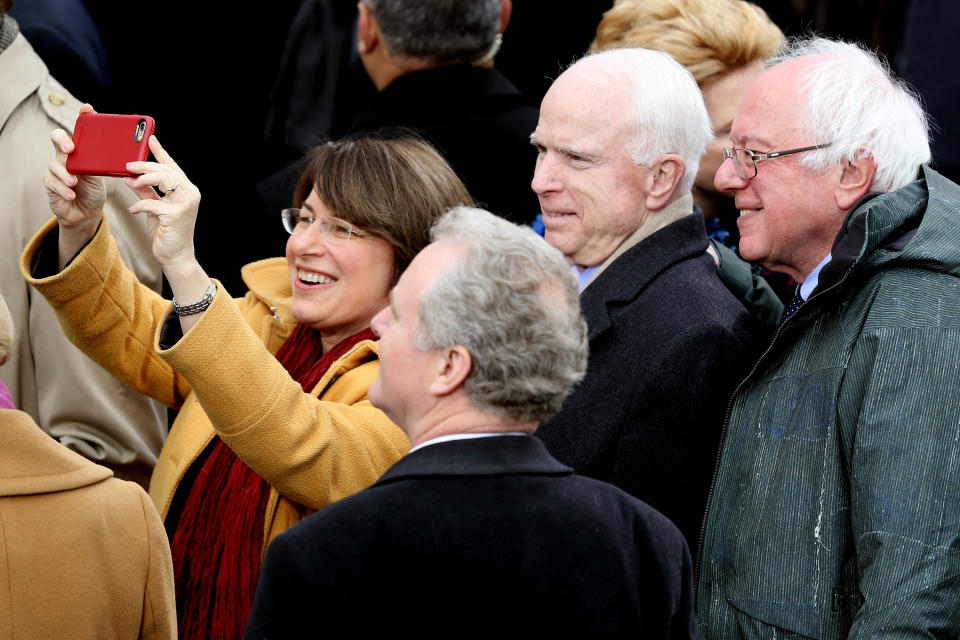 Sen. Amy Klobuchar (D-Minn.) takes a selfie with (from right) Sens. Bernie Sanders (I-Vt.), the late John McCain (R-Ariz.) and Chris Van Hollen (D-Md.) during President Donald Trump's inauguration in 2017. (Photo: Joe Raedle via Getty Images)