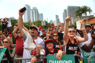 MIAMI, FL - JUNE 25: Fans cheer as Miami Heat players pass by in a victory parade through the streets during a celebration for the 2012 NBA Champion Miami Heat on June 25, 2012 in Miami, Florida. The Heat beat the Oklahoma Thunder to win the NBA title. (Photo by Joe Raedle/Getty Images)
