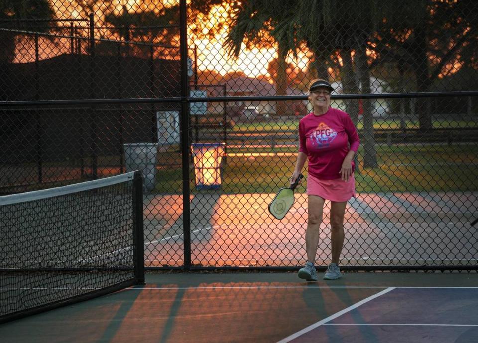 Odalis Pereira smiles during a game of pickleball at Tropical Park courts on Monday, Feb. 13, 2023, in Miami. After the death of her husband, Pereira said, starting to play pickleball changed her life by giving her a sense of community after loss.