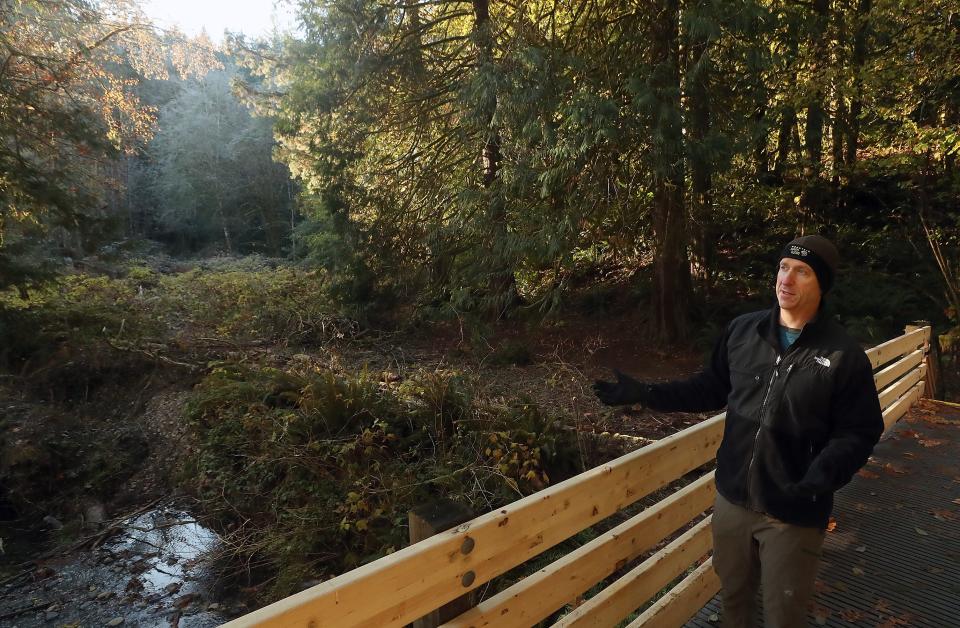 Keta Legacy Foundation president Jeff Wirtz talks about the new bridge built across Wildcat Creek as part of the Big Tree Trail in the Rhododendron Preserve on Nov. 18. The bridge, completed in October, is one of the new additions to the Rhododendron Preserve.