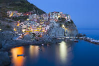 <p>On the Ligurian coast, the five villages of Cinque Terre — hence the name — make up just one of Italy’s 51 World Heritage Sites, the most of any country. Start in Monterossa and walk to Vernazza (or all the way Riomaggiore) on a path through terraced vineyards and overlooking the water. On your way, stop at local restaurants for seafood and pasta with pesto; the basil sauce was created in the area. World Heritage site since 1997. (Photo: Loop Images/UIG via Getty Images) </p>